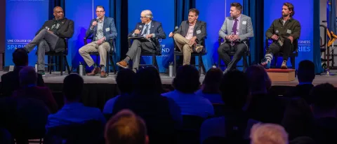 Panelists speak onstage in Innovation Hall