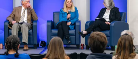 Three panelists discuss climate education onstage