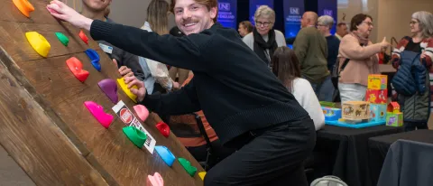 Students demonstrate their custom-made adaptive climbing wall