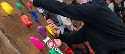 Students demonstrate their custom-made adaptive climbing wall