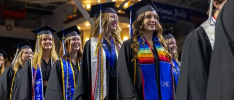 UNE students walk into the 2024 Commencement ceremony