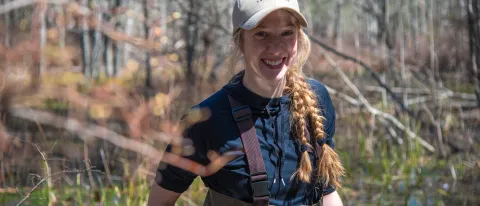 2024 Sustainability Fellow Juliann LaPierre poses for a portrait in the UNE forest 