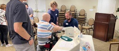 UNE occupational therapy students assist older adults at a wellness fair