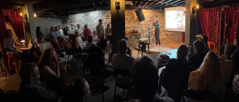 Julie Longua Peterson presents to a crowd at Novel in Portland