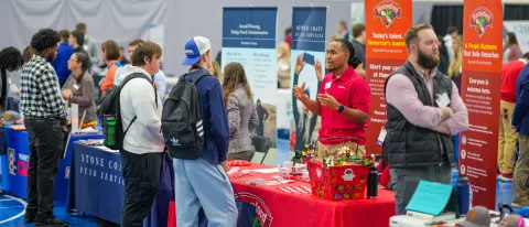 UNE students and employers talk at a career fair