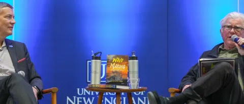 President Herbert on left with David Shaw on right speaking into micorphone