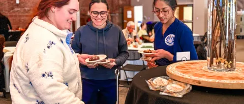 UNE students serve themselves at a luncheon in Innovation Hall