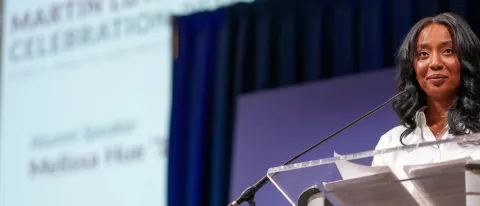 Melissa Hue standing at podium during MLK event