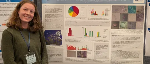 UNE student Lydia Jones poses in front of a research poster