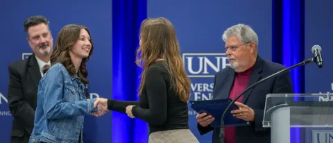 people shaking hands at this year's University Awards