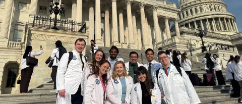 UNE medical students and faculty pose in front of the U.S. Capitol building