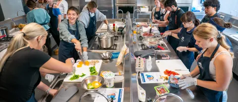 Students cook together in UNE's Teaching Kitchen