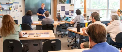 UNE professor Jeremy Pare speaks to a classroom