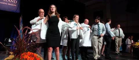 Members of the UNE COM Class of 2020 receive their white coats