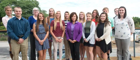 UNE President Danielle Ripich (front, center), Mitchell Institute President and CEO Meg Baxter (back row, second from left) and 