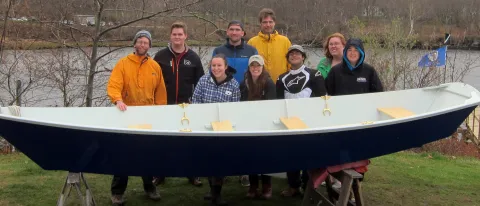 Members of the UNE Boatbuilding course pose with Sea Basket before the launch.