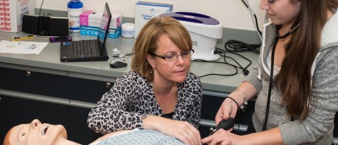Interprofessional Simulation and Innovation Center Director Dawne-Marie Dunbar guides student through a training experience