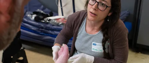 UNE Nursing Marcie Ristich treats a client at Milestone Recovery in Portland 