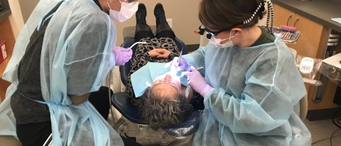 College of Dental Medicine students Chris Priest and Stephanie Beeckel provide free dental care at the Oral Health Center 