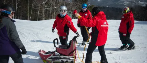 Julia Currier (wearing the silver helmet) at her internship site at Maine Adaptive & Recreation, housed at Sunday River ski reso