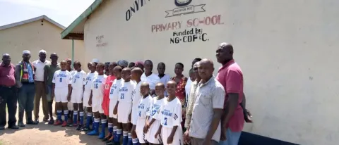 Students in Kenya wear uniforms donated by the UNE soccer program