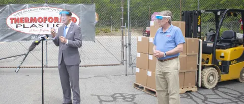 UNE President James Herbert speaks to reporters with Paul Tyson, Thermoformed Plastics of New England founder, general manager