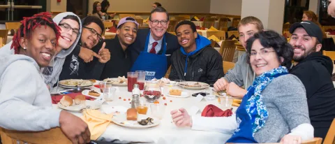 President Herbert and students at annual UNE Thanksgiving meal