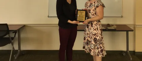 Cat Martins, UNE benefits and disability specialist, accepts the award