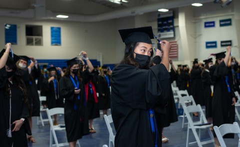 A student turns her tassel as she graduates from the Westbrook College of Health Professions