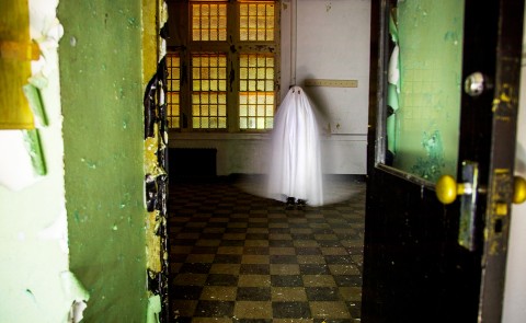 Digital art piece showing white ghost inside empty room