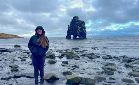Ariana Telzerow stands in front of the water in Iceland