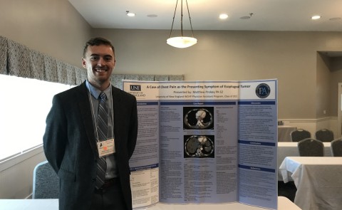 PA student Matt Prokey stands next to a poster he presented