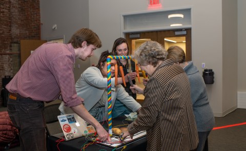 Expo attendees play with a sensory piano created by M.S.O.T. students