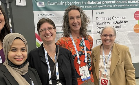 UNE researchers pose in front of a poster they presented at the American Public Health Association’s 150th Anniversary Annual Meeting 