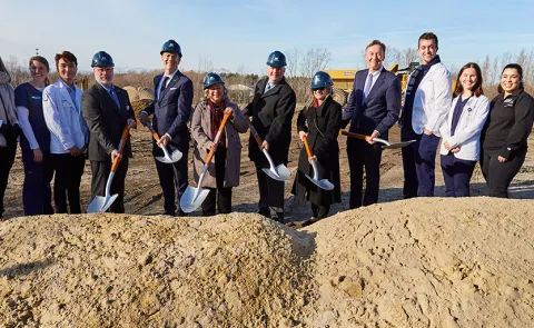 UNE leadership dig into the earth at the groundbreaking ceremony for the Harold and Bibby Center for Health Sciences on Tuesday, Nov. 29, 2022