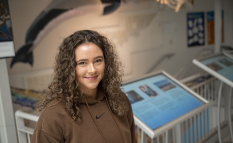 Portrait of Isabella Dube (Marine Affairs, ’24) in UNE's Marine Science Center