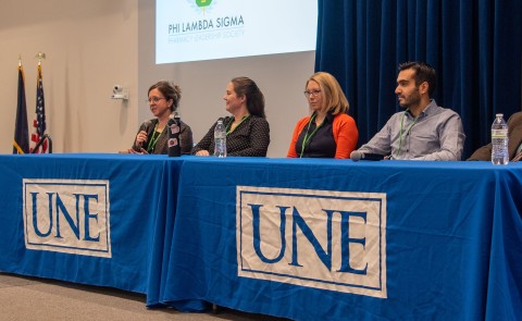 A group of interprofessional health care providers speaks to students as part of the conference