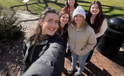 A group of UNE students and faculty take a selfie in front of Philadelphia's Independence Hall