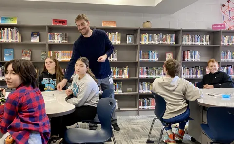 A UNE professor interacts with middle schoolers from Saco at Maine Bioscience Day