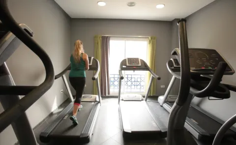A woman runs on a treadmill