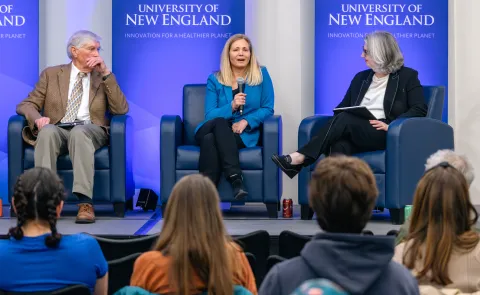 Three panelists discuss climate education onstage