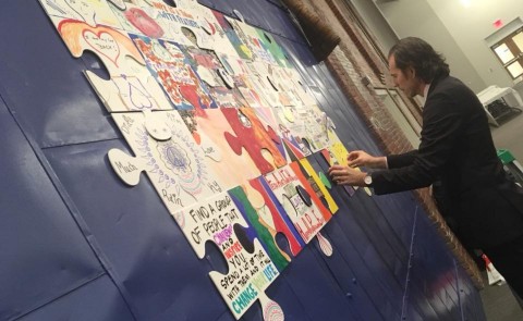 UNE social work student Glenn Simpson unveiled his recovery puzzle at the Southern Maine Harm Reduction Conference 