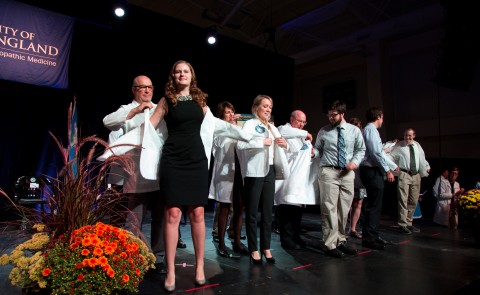 Members of the UNE COM Class of 2020 receive their white coats