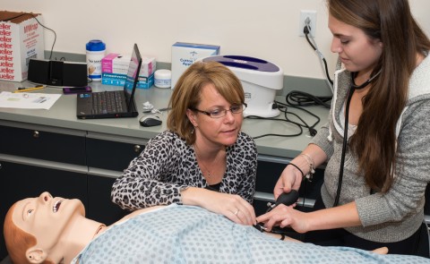 Interprofessional Simulation and Innovation Center Director Dawne-Marie Dunbar guides student through a training experience
