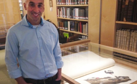 Noah Perlut stands beside Bowdoin College’s copy of the double-elephant folio edition of Audubon’s Birds of America. The red-he