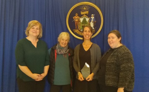 Jen Gunderman (second from left) received the award during a ceremony at the Maine Statehouse