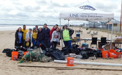 A UNE-led team of volunteers cleared 500 pounds of trash off the beach in Old Orchard Beach