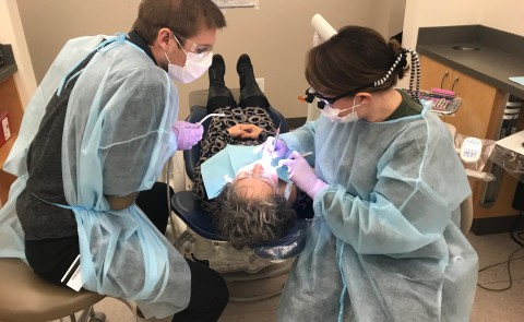 College of Dental Medicine students Chris Priest and Stephanie Beeckel provide free dental care at the Oral Health Center 