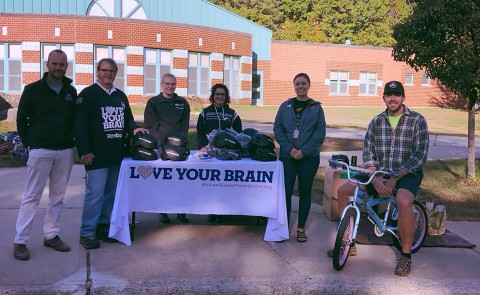 UNE students and faculty worked with volunteers from the Michael T. Goulet foundation to fit and distribute over 350 helmets