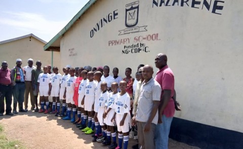 Students in Kenya wear uniforms donated by the UNE soccer program